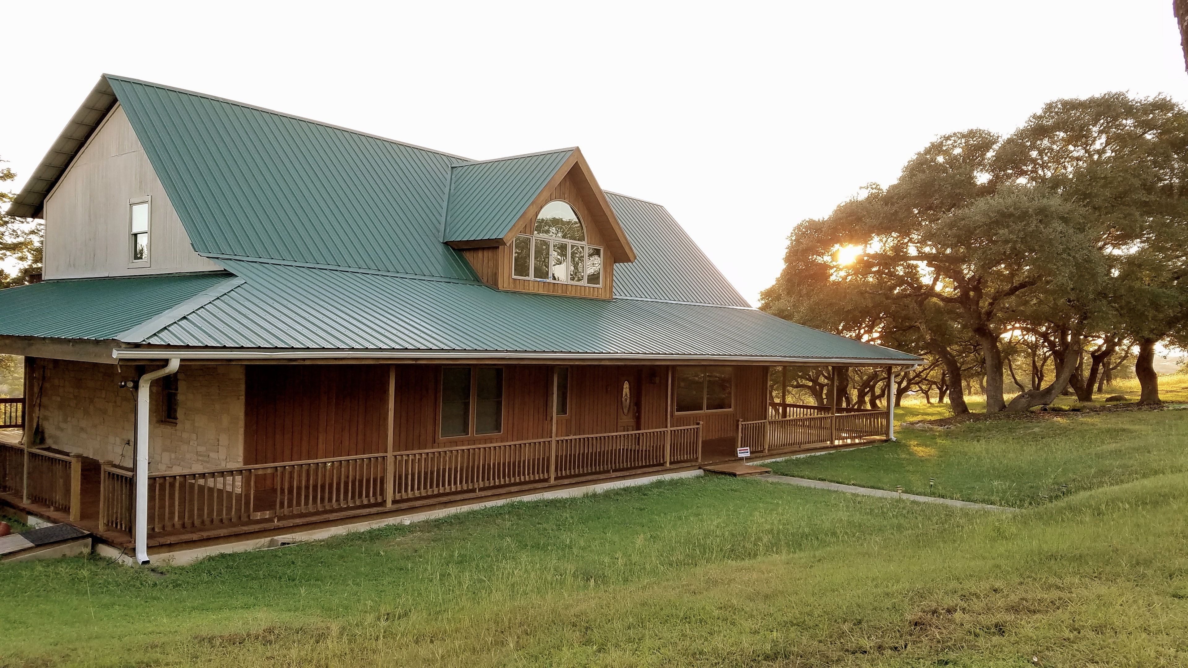 The hilltop ranch house with its wrap-around porch at The Ranch at Bell Springs