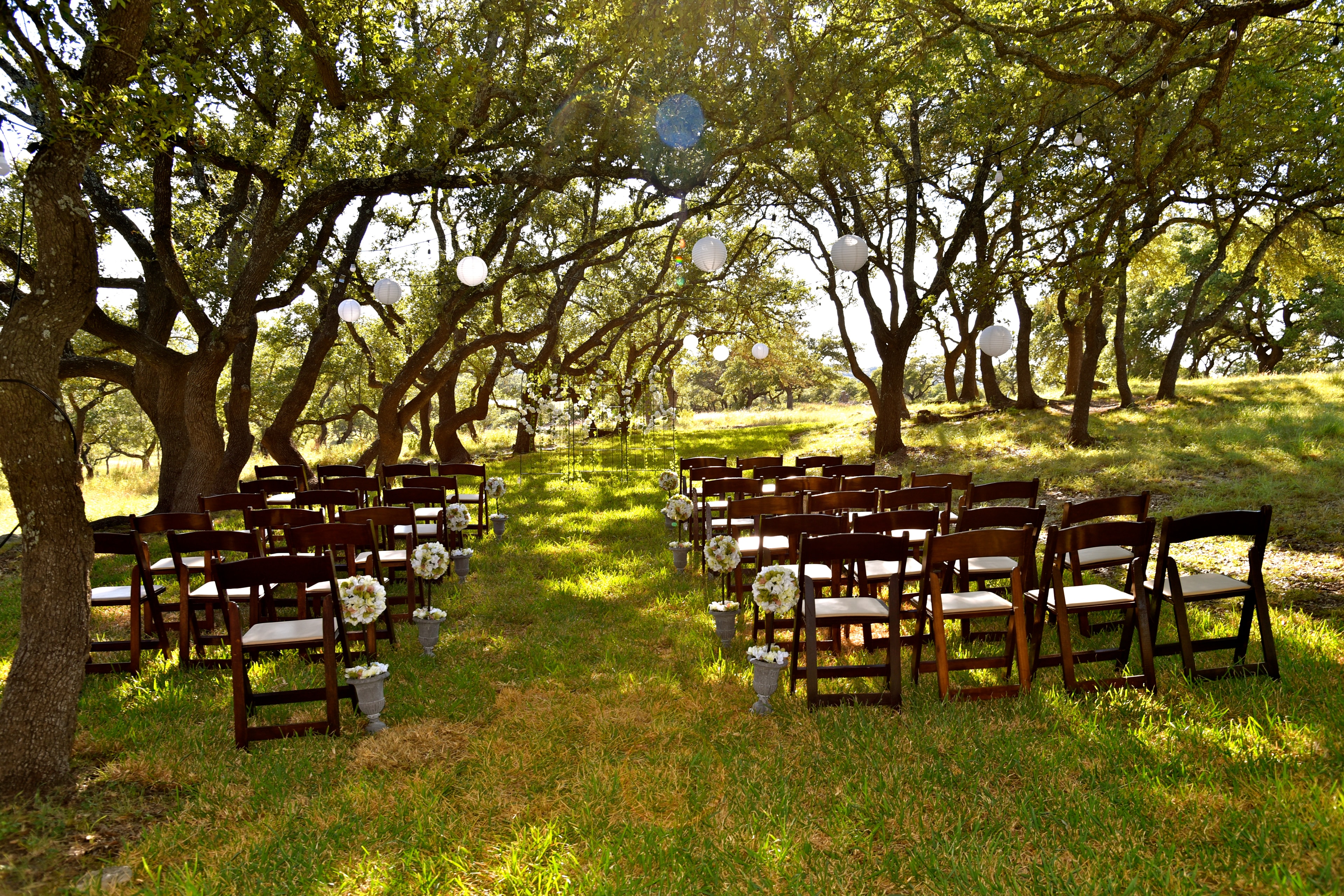 Wedding ceremony chairs set up beneath the live oak trees at The Ranch at Bell Springs